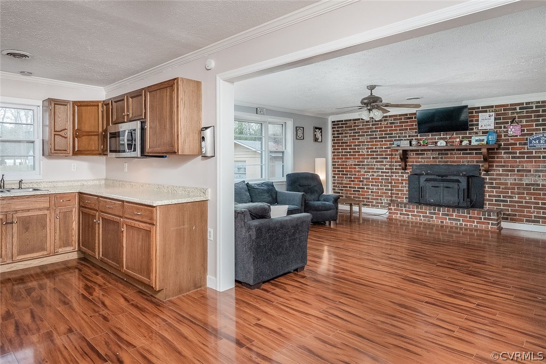 9420 Townsend Road Providence Forge, VA 23140 - Photo 10 of 29 a kitchen with wooden floors and a fireplace