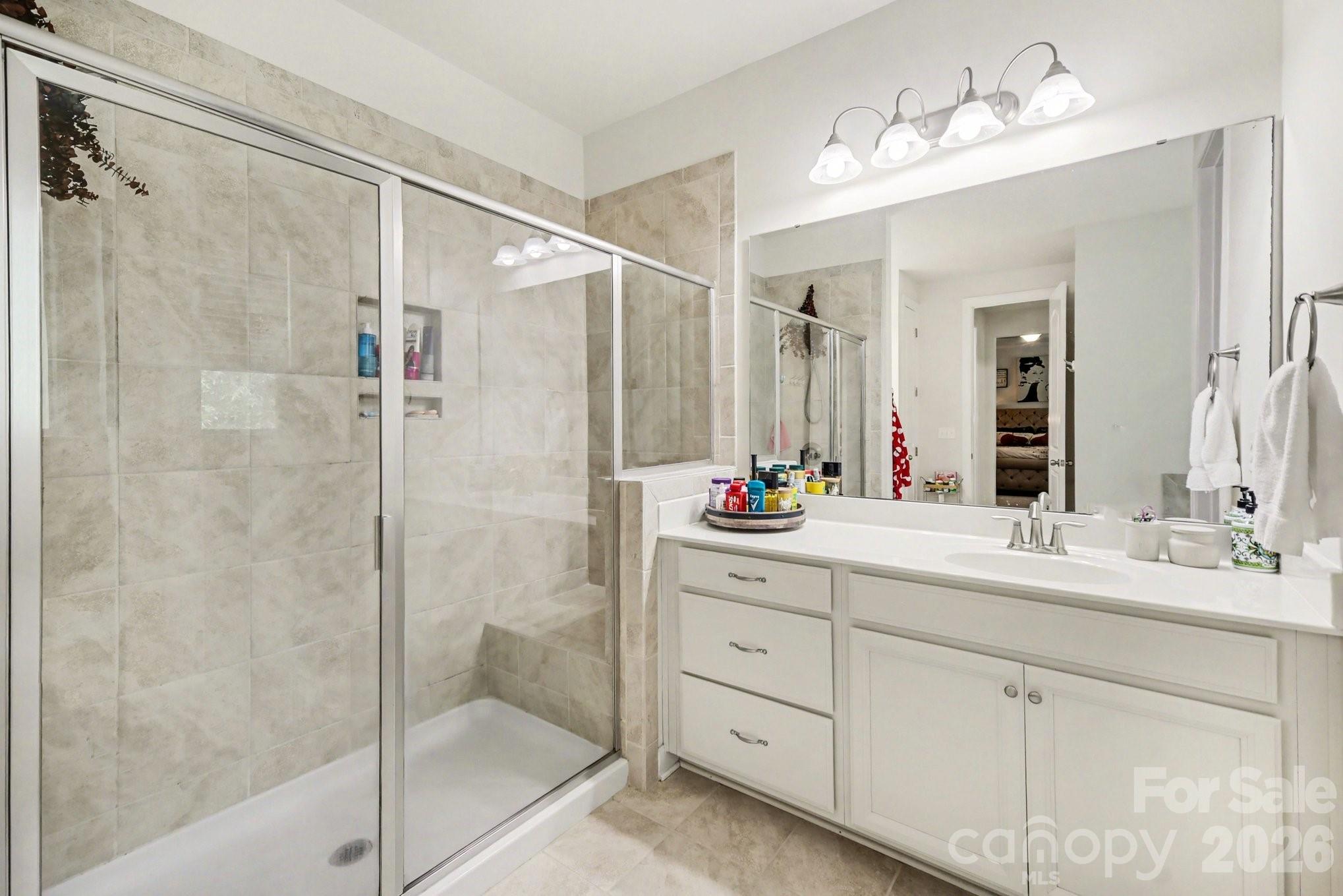 5327 Baker Lane Clover, SC 29710 - Photo 19 of 34 a bathroom with a double vanity sink mirror and shower