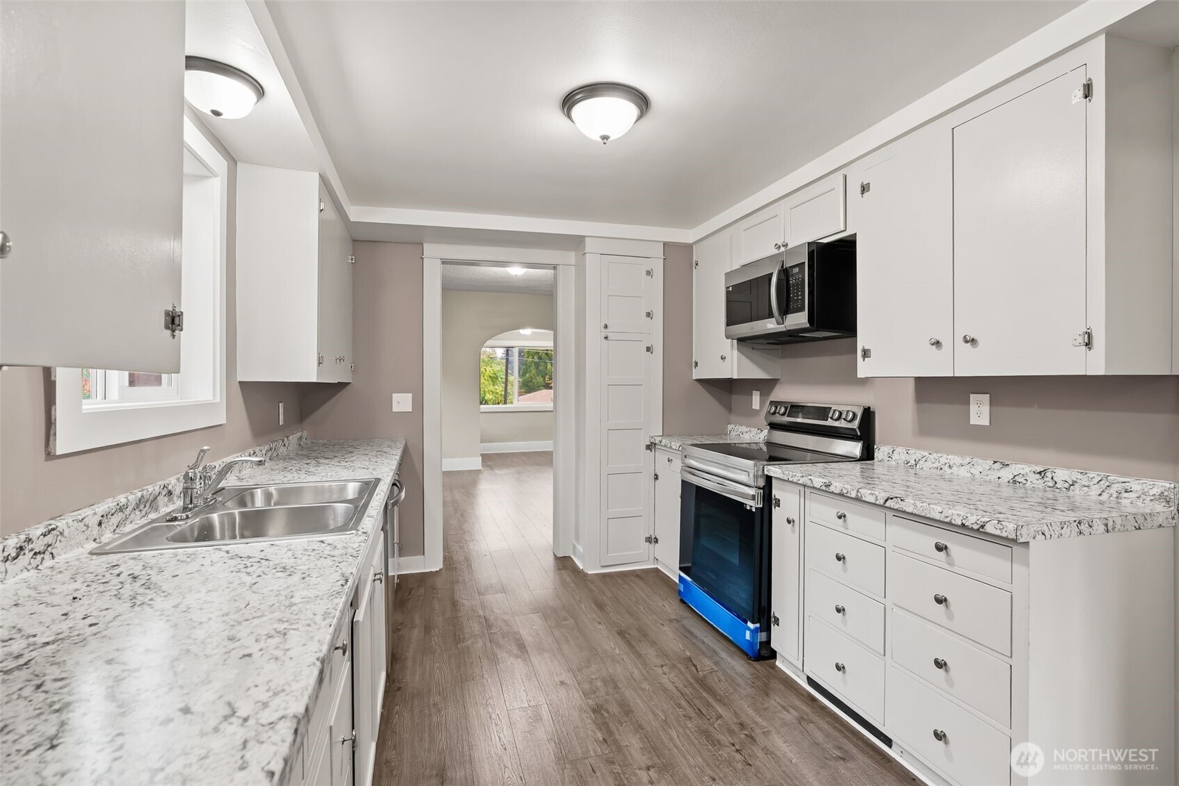 2214 Summitview Avenue Yakima, WA 98902 - Photo 12 of 30 a kitchen with stainless steel appliances granite countertop a stove top oven a sink a microwave and wooden floors
