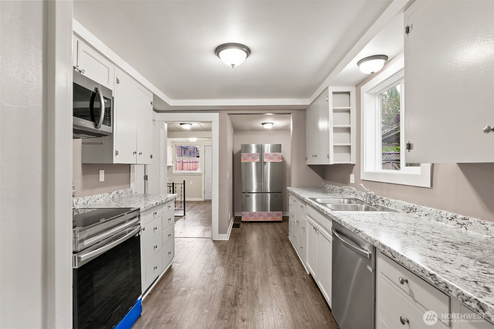 2214 Summitview Avenue Yakima, WA 98902 - Photo 13 of 30 a large kitchen with stainless steel appliances granite countertop a lot of counter space and wooden floor