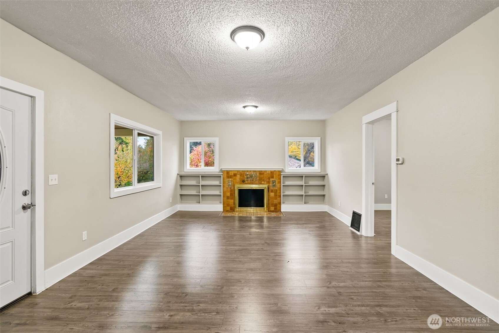 2214 Summitview Avenue Yakima, WA 98902 - Photo 7 of 30 an empty room with wooden floor fireplace and windows