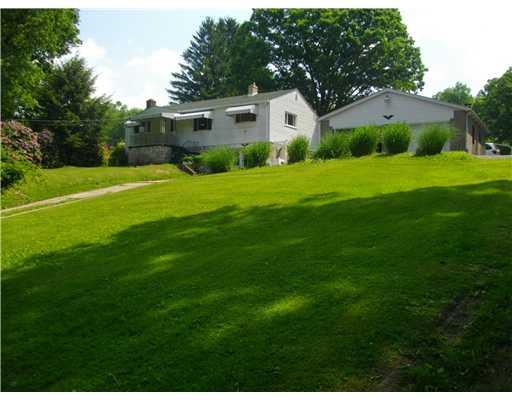 5554 Gibson Road Gibsonia, PA 15044 - Photo 1 of 18 Exterior Front. Front of House offset from Street. Two-Car Detached Garage to Right. Has newer roof as does the house. Garage doors are newer and have openers. Bulk of property, and flat part is behind the house.