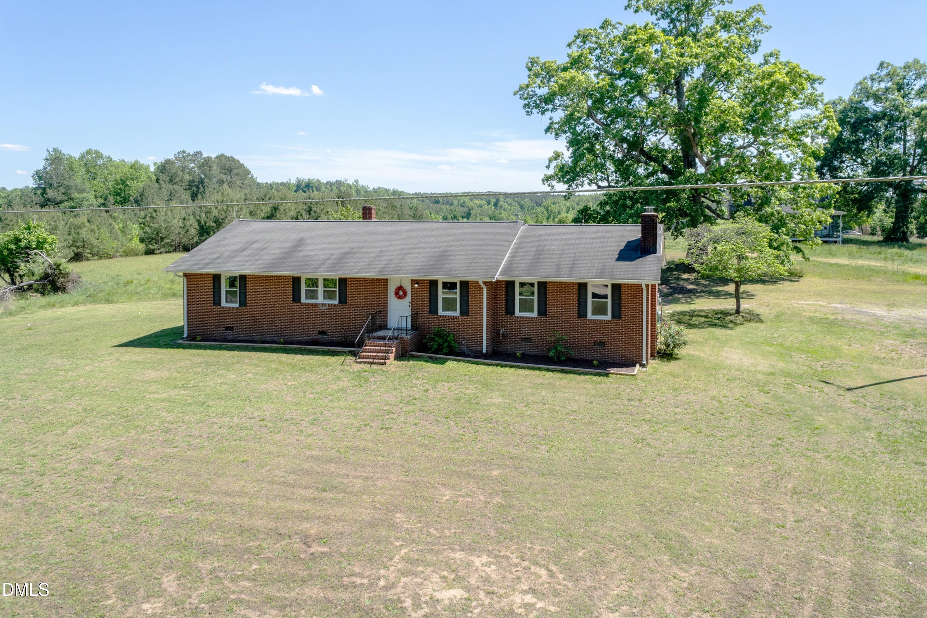 641 Rocky Ford Road Louisburg, NC 27549 - Photo 4 of 38 a front view of a house with a garden