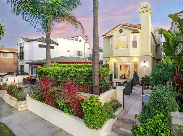 a front view of a house with a garden and patio