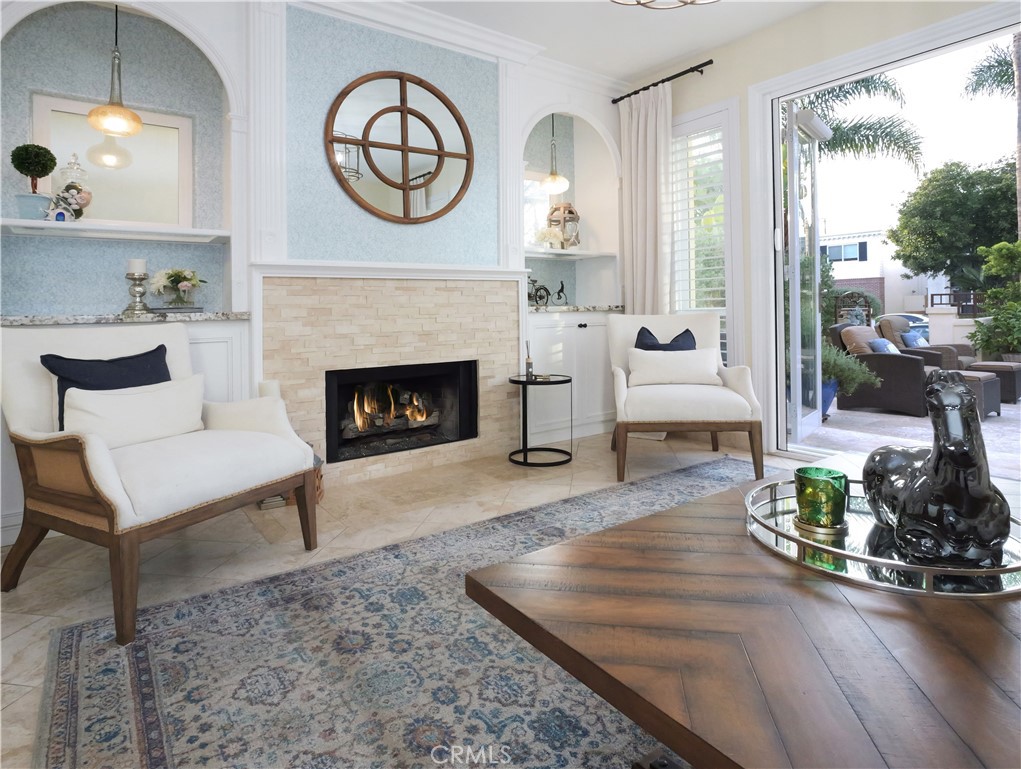 320 15th Street Huntington Beach, CA 92648 - Photo 11 of 49 a living room with furniture a fireplace and a floor to ceiling window