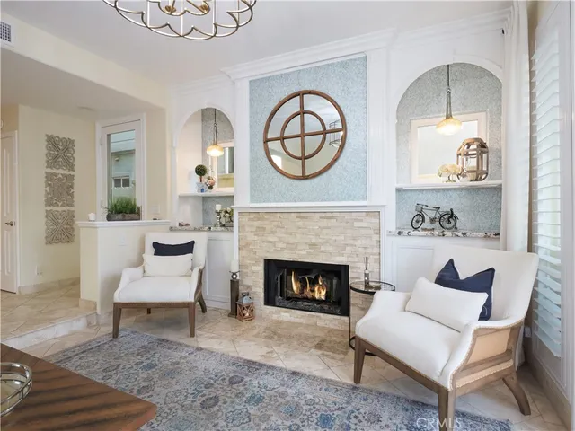 a living room with furniture a clock and a fireplace