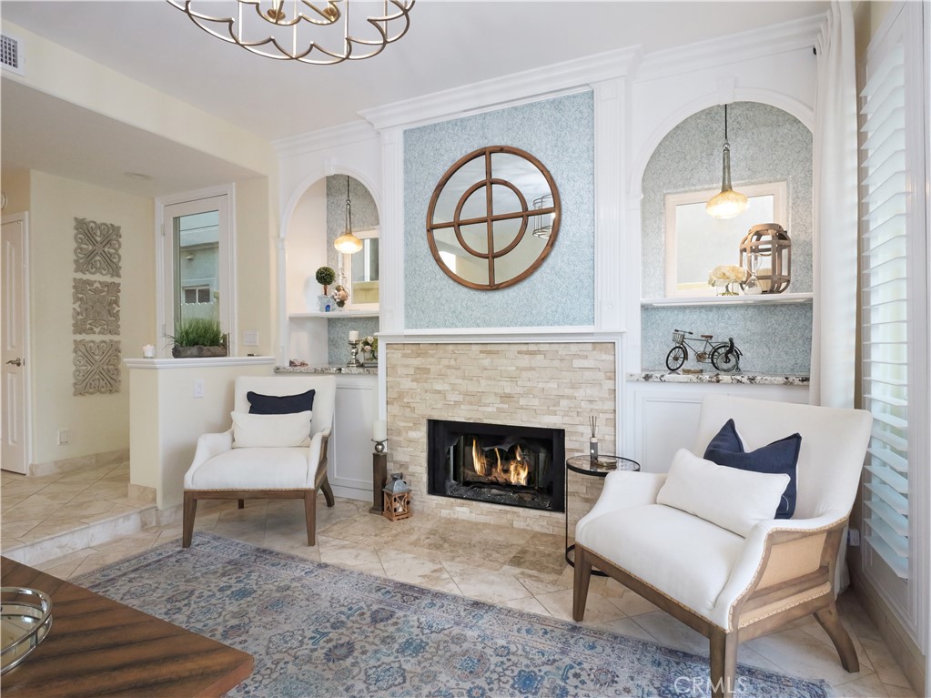 320 15th Street Huntington Beach, CA 92648 - Photo 12 of 49 a living room with furniture a clock and a fireplace