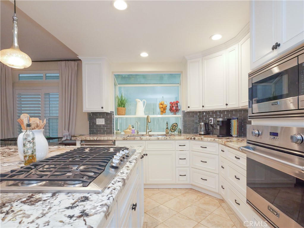 320 15th Street Huntington Beach, CA 92648 - Photo 20 of 49 a bedroom with a bed and a stove top oven