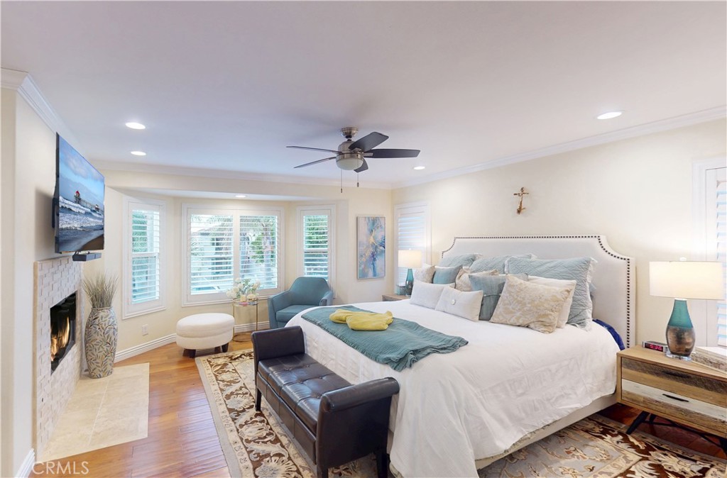 320 15th Street Huntington Beach, CA 92648 - Photo 21 of 49 a bedroom with a bed couch and a fireplace