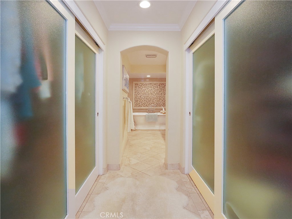 320 15th Street Huntington Beach, CA 92648 - Photo 25 of 49 a view of a hallway to an empty room and wooden shelves