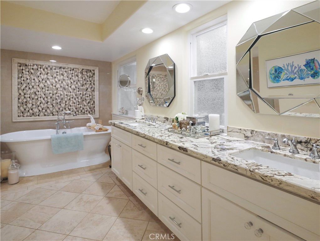 320 15th Street Huntington Beach, CA 92648 - Photo 27 of 49 a spacious bathroom with a granite countertop sink mirror and bathtub