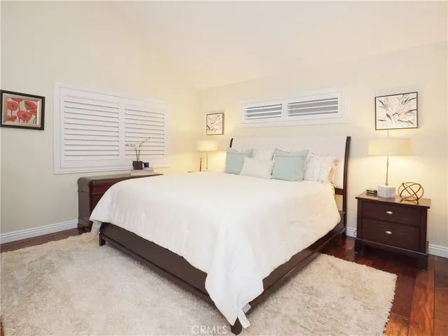 a bedroom with a bed and a night stand