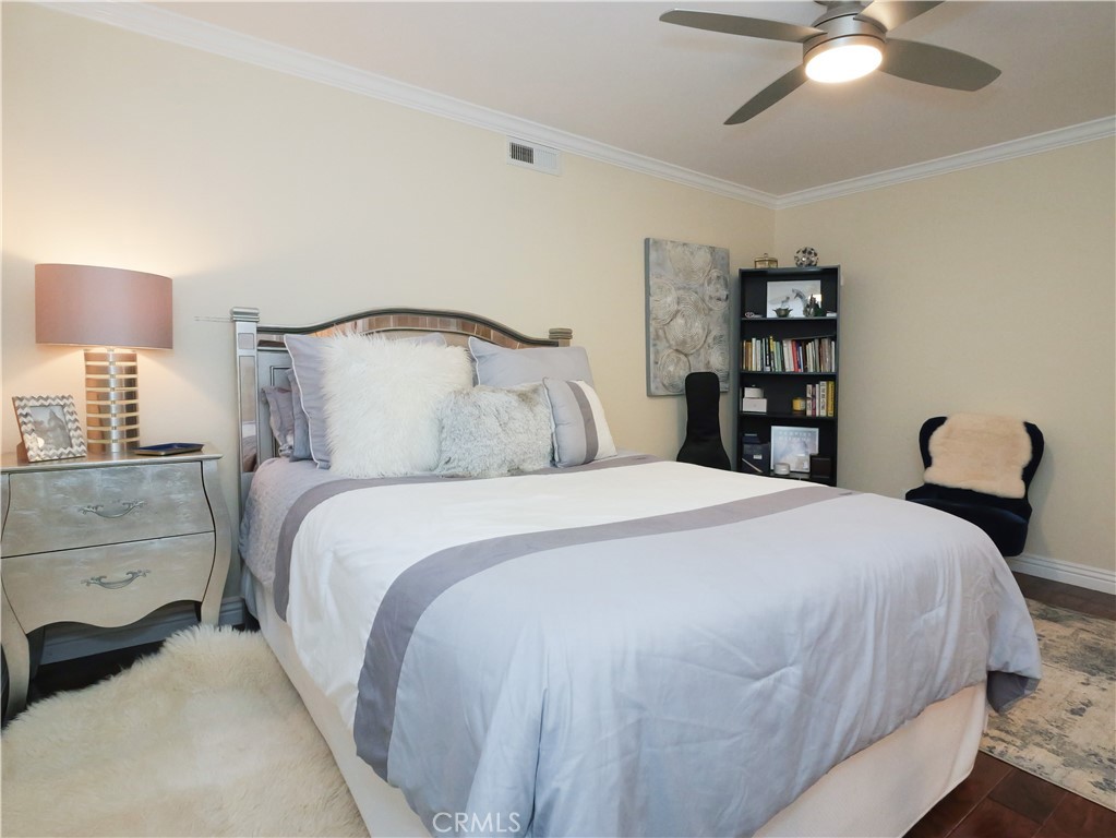 320 15th Street Huntington Beach, CA 92648 - Photo 30 of 49 a bedroom with a bed and a chandelier