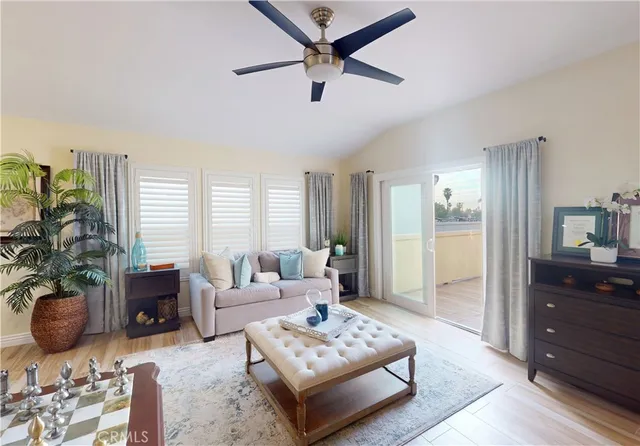 a living room with furniture a window and a potted plant