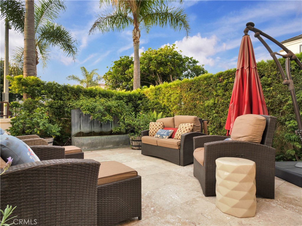 320 15th Street Huntington Beach, CA 92648 - Photo 6 of 49 a view of a patio with couches and a table and chairs