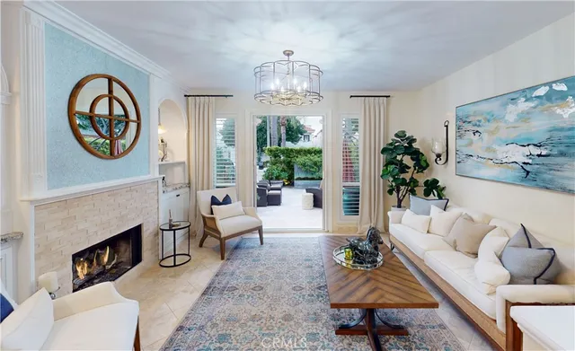 a living room with furniture a fireplace and a large mirror