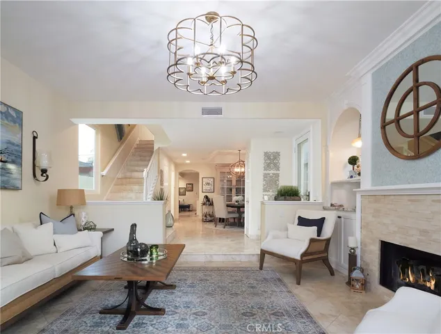 a living room with furniture a fireplace and a table