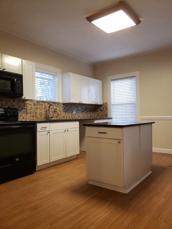 55 Tyler Street Springfield, MA 01109 - Photo 17 of 32 a kitchen with granite countertop a sink cabinets and stainless steel appliances