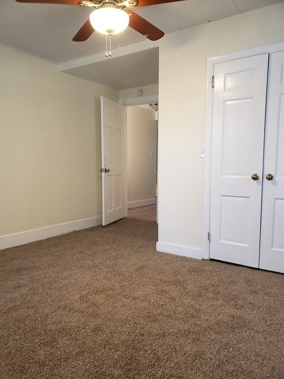 55 Tyler Street Springfield, MA 01109 - Photo 22 of 32 an empty room with a empty space and a ceiling fan
