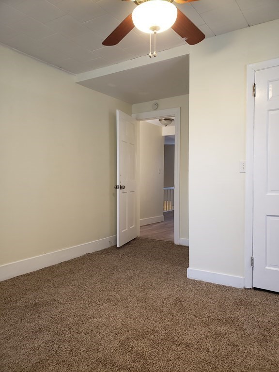 55 Tyler Street Springfield, MA 01109 - Photo 24 of 32 an empty room with chandelier fan