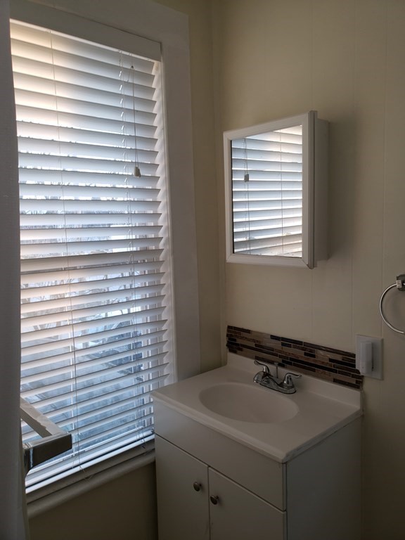 55 Tyler Street Springfield, MA 01109 - Photo 26 of 32 a bathroom with a sink and a window