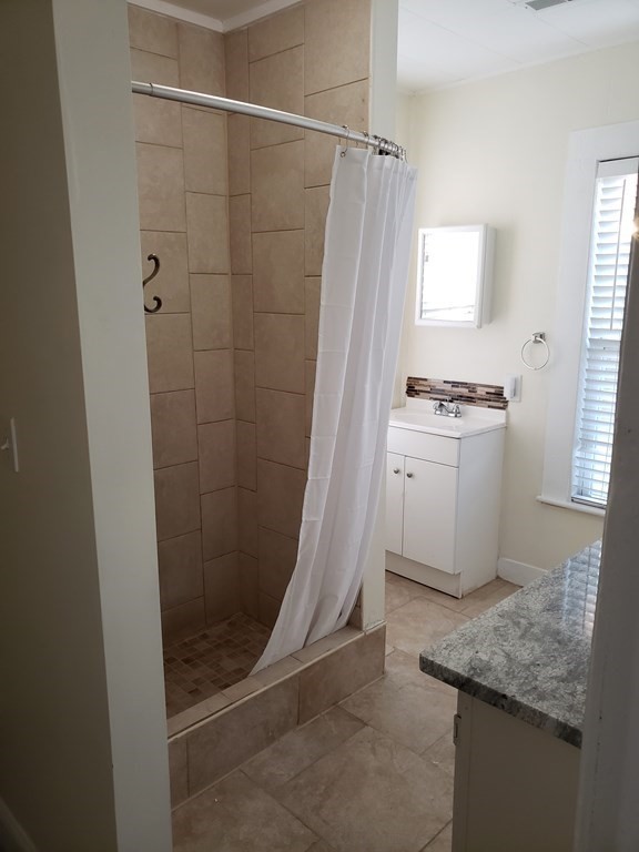 55 Tyler Street Springfield, MA 01109 - Photo 29 of 32 a bathroom with a granite countertop sink a toilet and shower