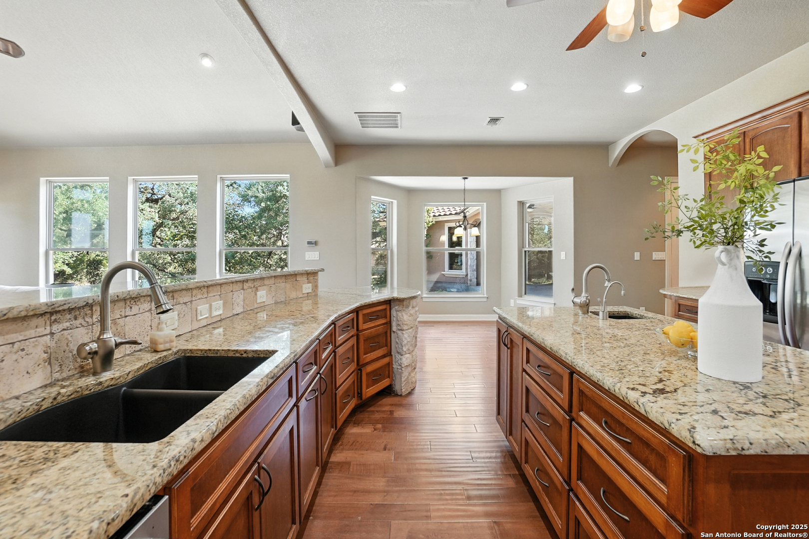 7607 Sky Loop Garden Ridge, TX 78266 - Photo 12 of 49 a kitchen with stainless steel appliances granite countertop a sink and a stove