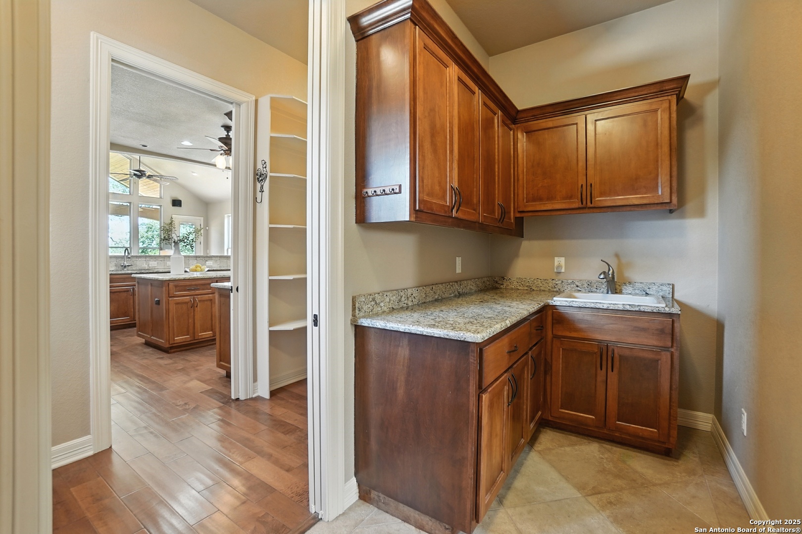 7607 Sky Loop Garden Ridge, TX 78266 - Photo 14 of 49 a kitchen with a sink and a refrigerator