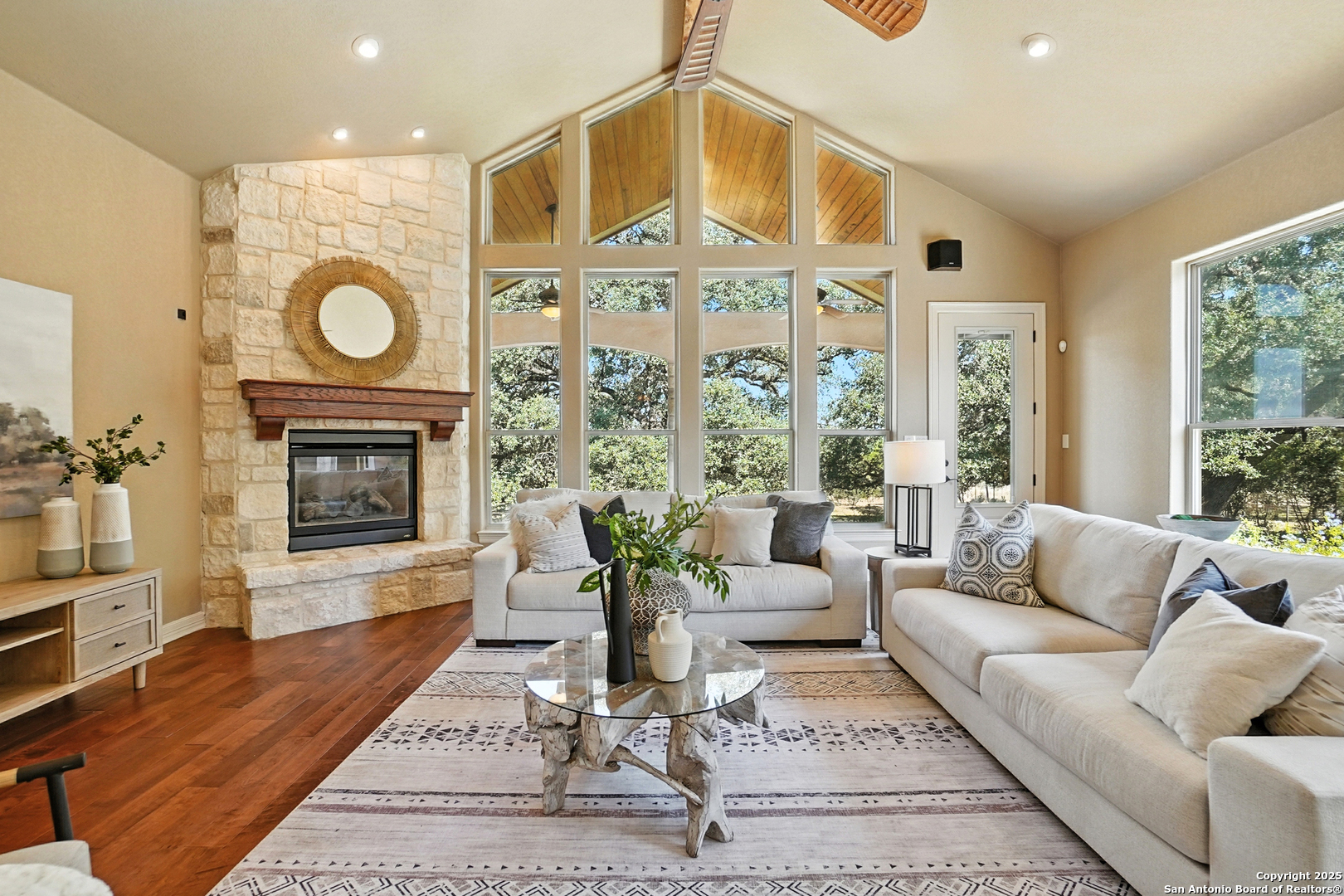 7607 Sky Loop Garden Ridge, TX 78266 - Photo 16 of 49 a living room with furniture a fireplace and a floor to ceiling window