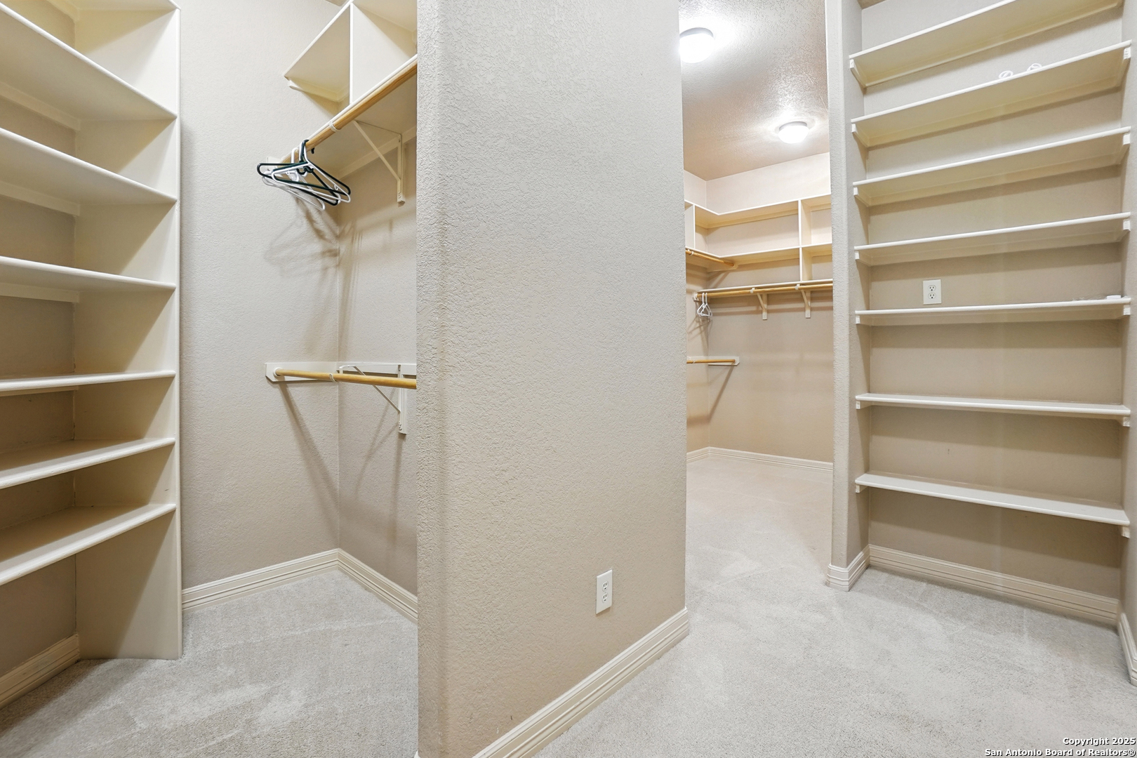 7607 Sky Loop Garden Ridge, TX 78266 - Photo 23 of 49 a view of walk in closet with empty racks