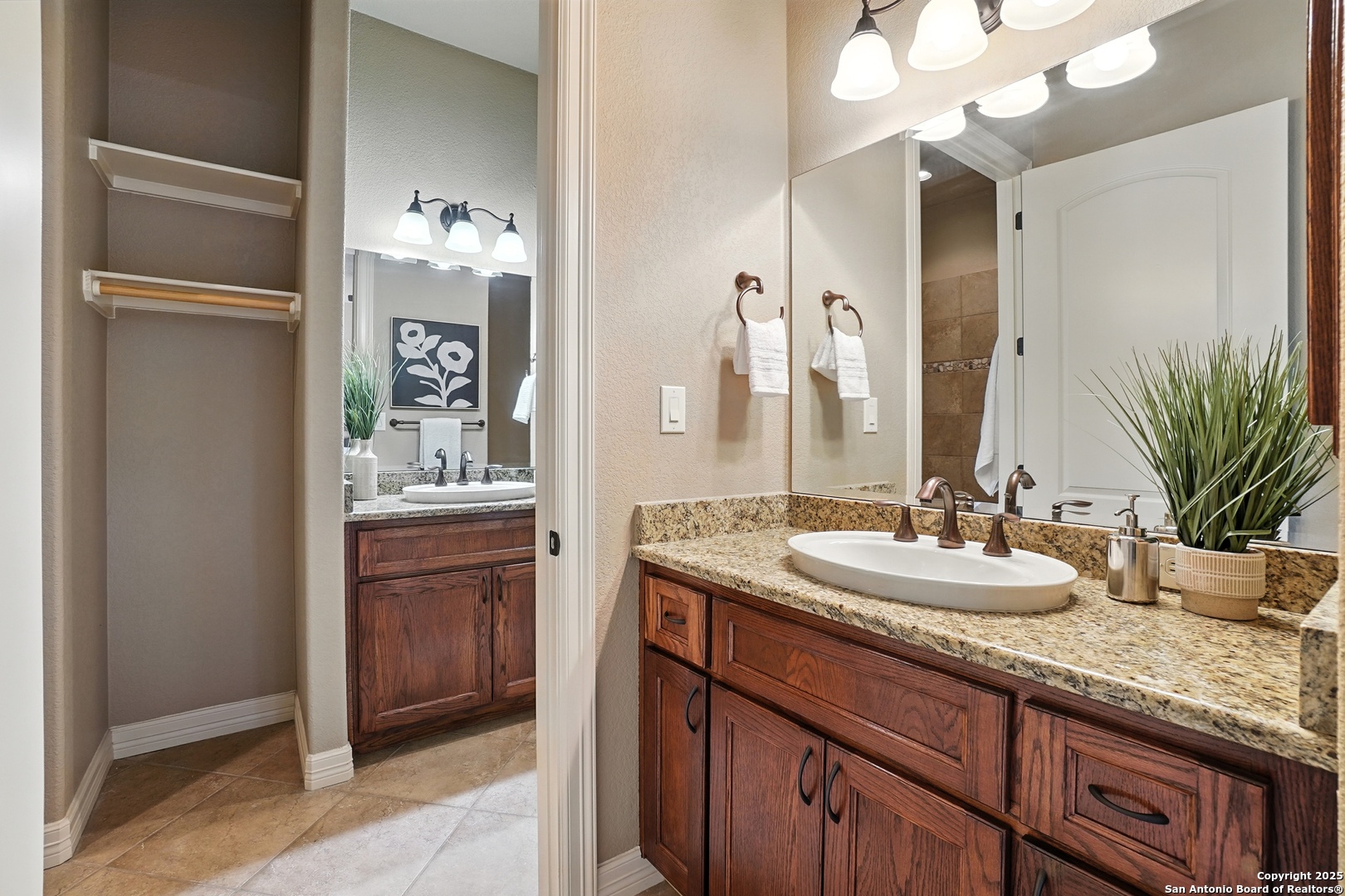 7607 Sky Loop Garden Ridge, TX 78266 - Photo 26 of 49 a bathroom with a granite countertop sink and a mirror