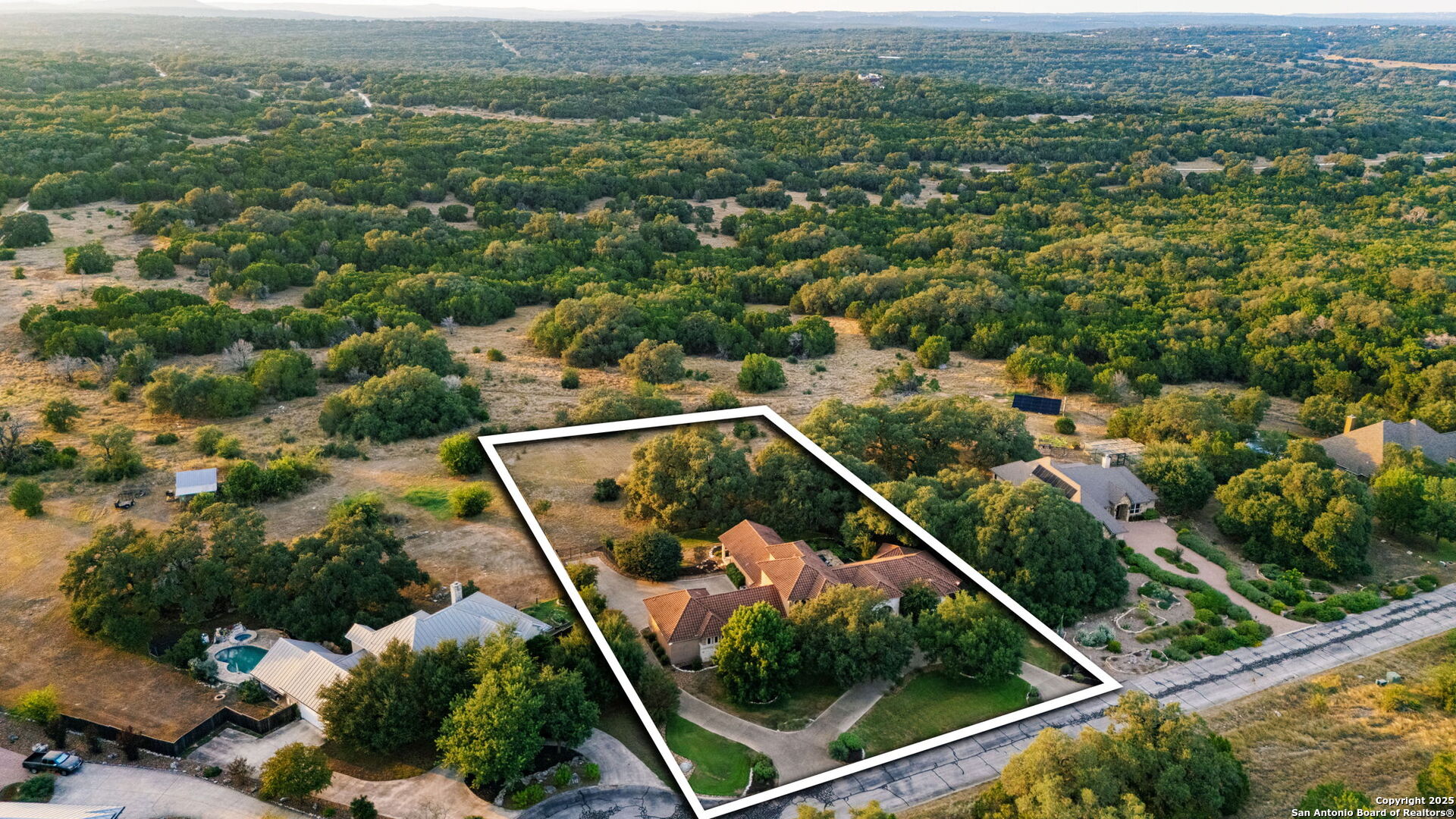 7607 Sky Loop Garden Ridge, TX 78266 - Photo 46 of 49 an aerial view of residential houses with outdoor space and trees