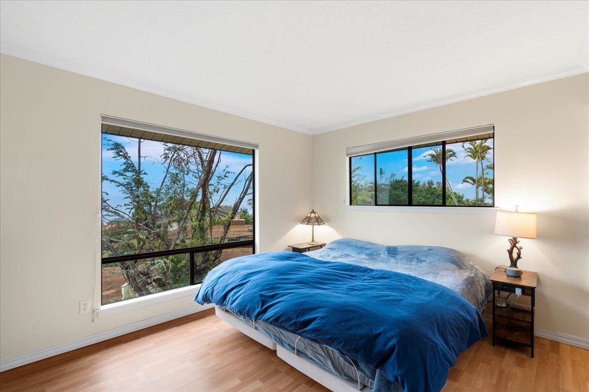 119 Ka Drive Kula, HI 96790 - Photo 23 of 45 a bed sitting in a bedroom next to a window
