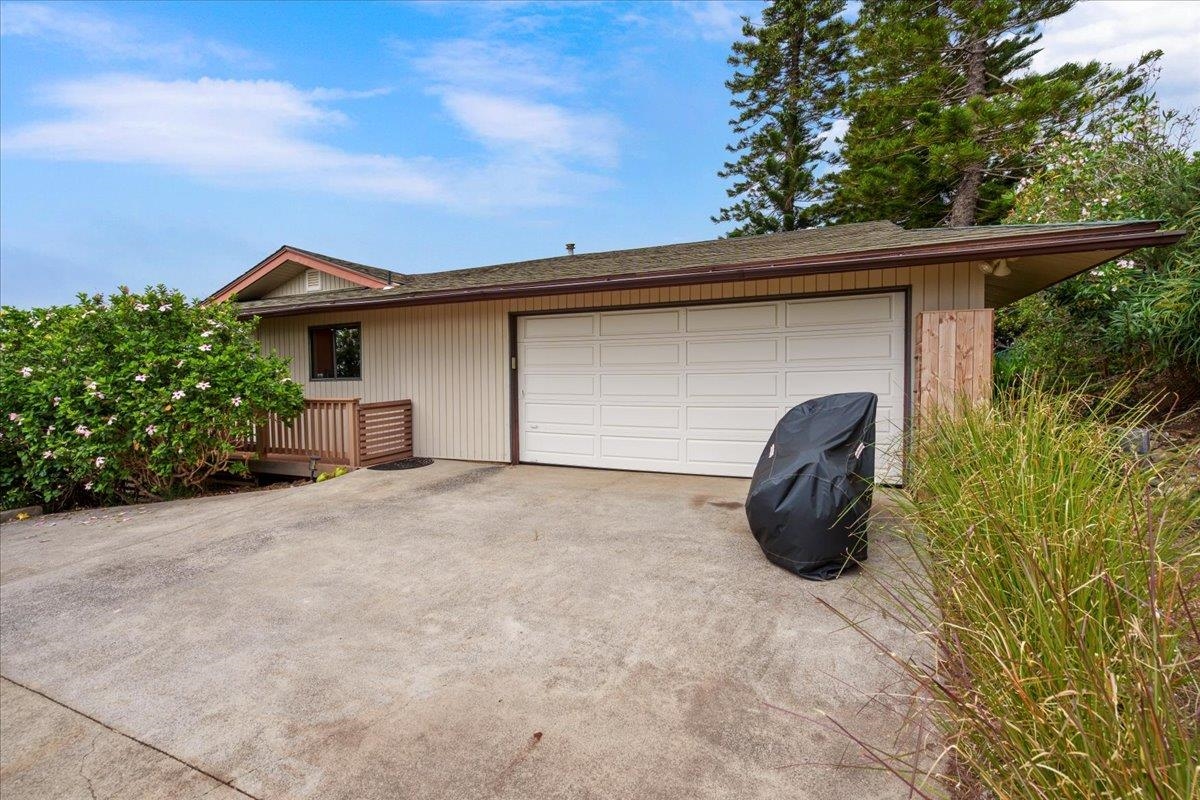 119 Ka Drive Kula, HI 96790 - Photo 42 of 45 a front view of a house with a yard and garage