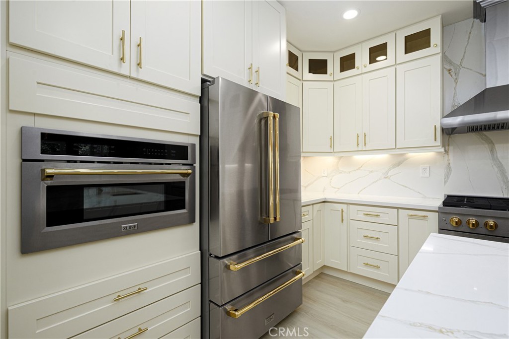 15 Plum Street Ladera Ranch, CA 92694 - Photo 25 of 113 a kitchen with stainless steel appliances white cabinets and a refrigerator