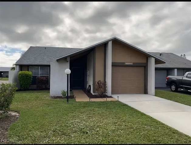a view of a house with backyard and porch