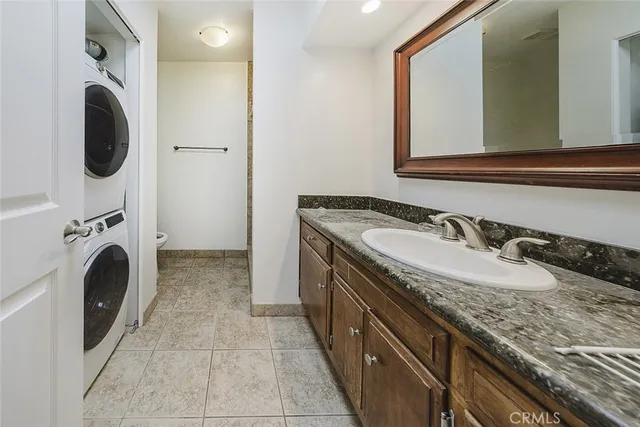 a utility room with sink dryer and washer