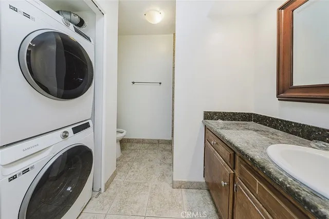 a utility room with sink dryer and washer