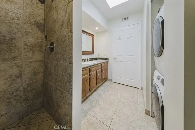 an empty room with wooden floor fireplace and windows