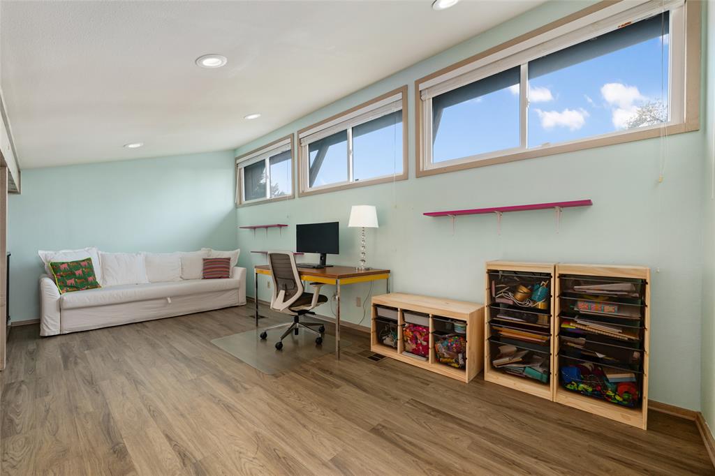 2210 Red Fox Road Austin, TX 78734 - Photo 33 of 40 Sun-filled room with wood flooring offers versatile living space.