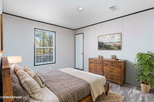 a bedroom with a bed and a dresser