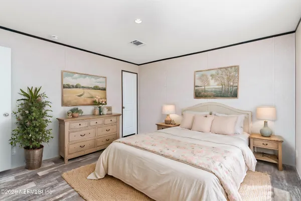a bedroom with a bed and a dresser