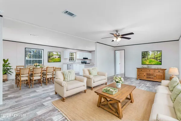 a living room with furniture and wooden floor