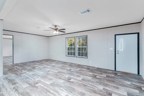 a view of a livingroom with a ceiling fan and window
