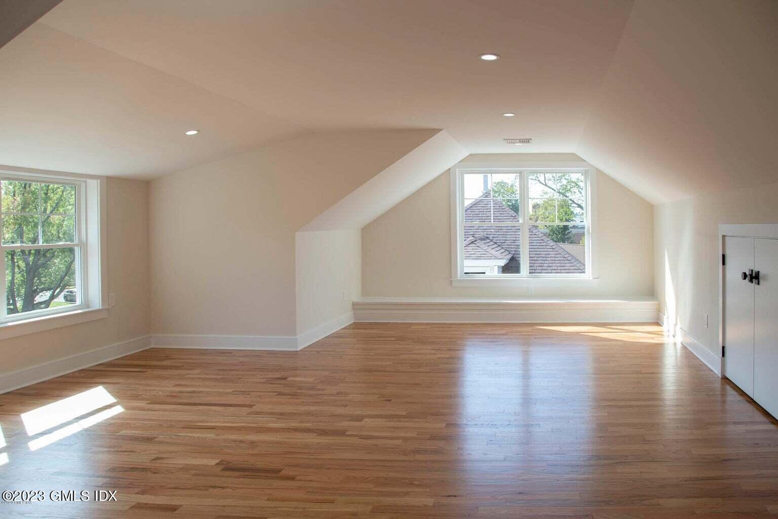 292 Delavan Avenue, Unit 2 Greenwich, CT 06830 - Photo 14 of 22 an empty room with wooden floor and windows
