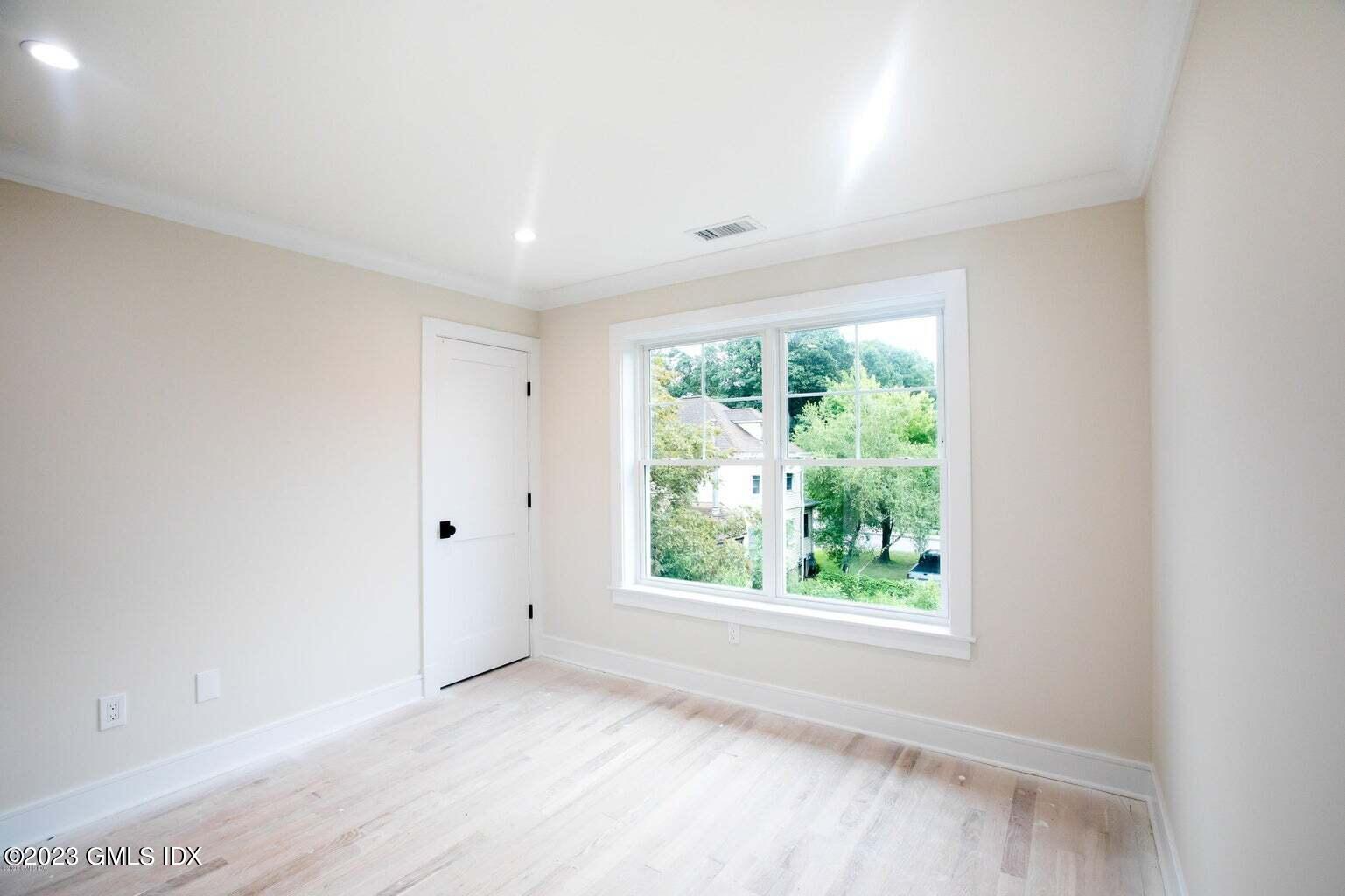 292 Delavan Avenue, Unit 2 Greenwich, CT 06830 - Photo 17 of 22 wooden floor in an empty room with a window