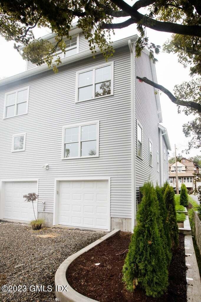 292 Delavan Avenue, Unit 2 Greenwich, CT 06830 - Photo 2 of 22 a view of a yard in front of house