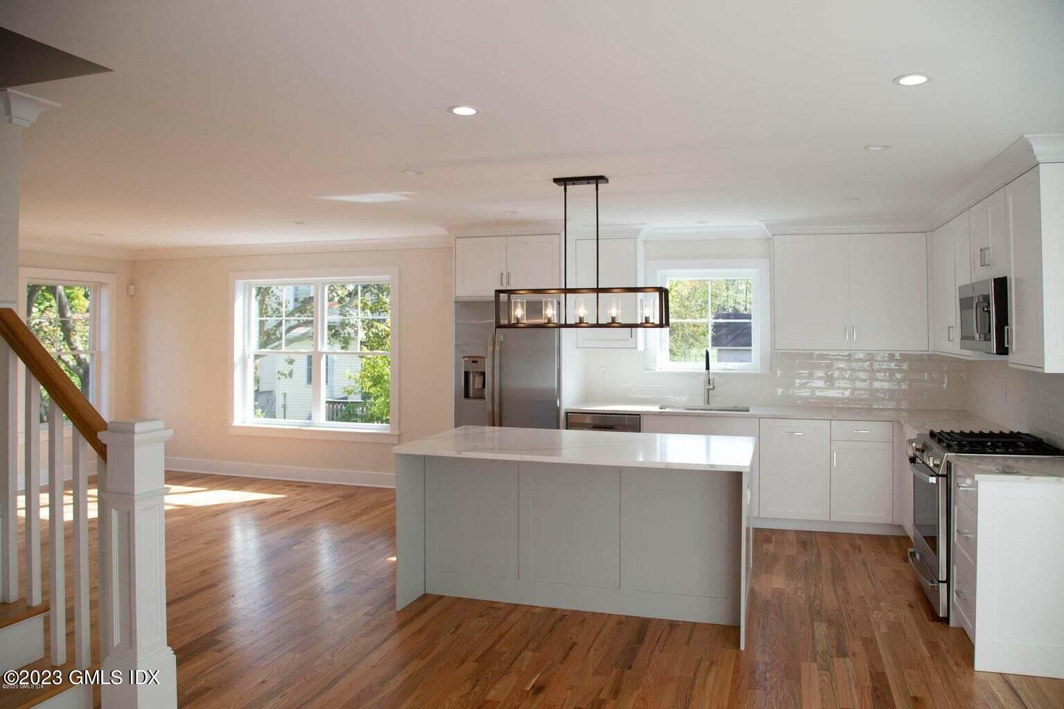 292 Delavan Avenue, Unit 2 Greenwich, CT 06830 - Photo 3 of 22 a kitchen with stainless steel appliances granite countertop a sink a stove and a wooden floors