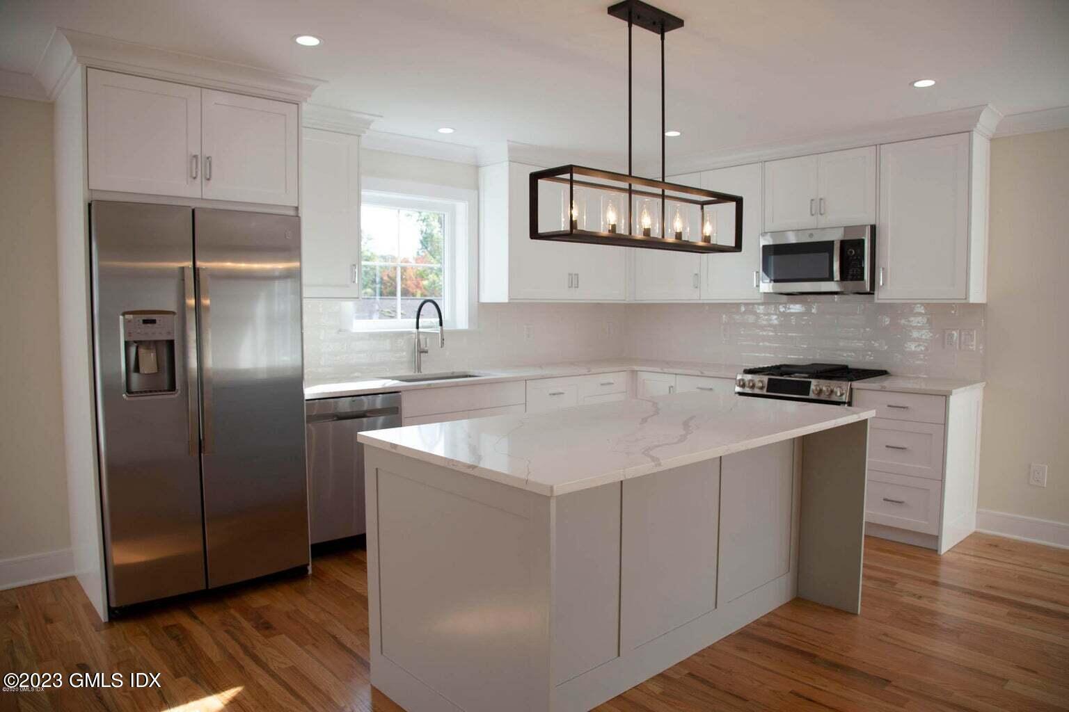 292 Delavan Avenue, Unit 2 Greenwich, CT 06830 - Photo 5 of 22 a kitchen with stainless steel appliances granite countertop a sink a refrigerator and a stove