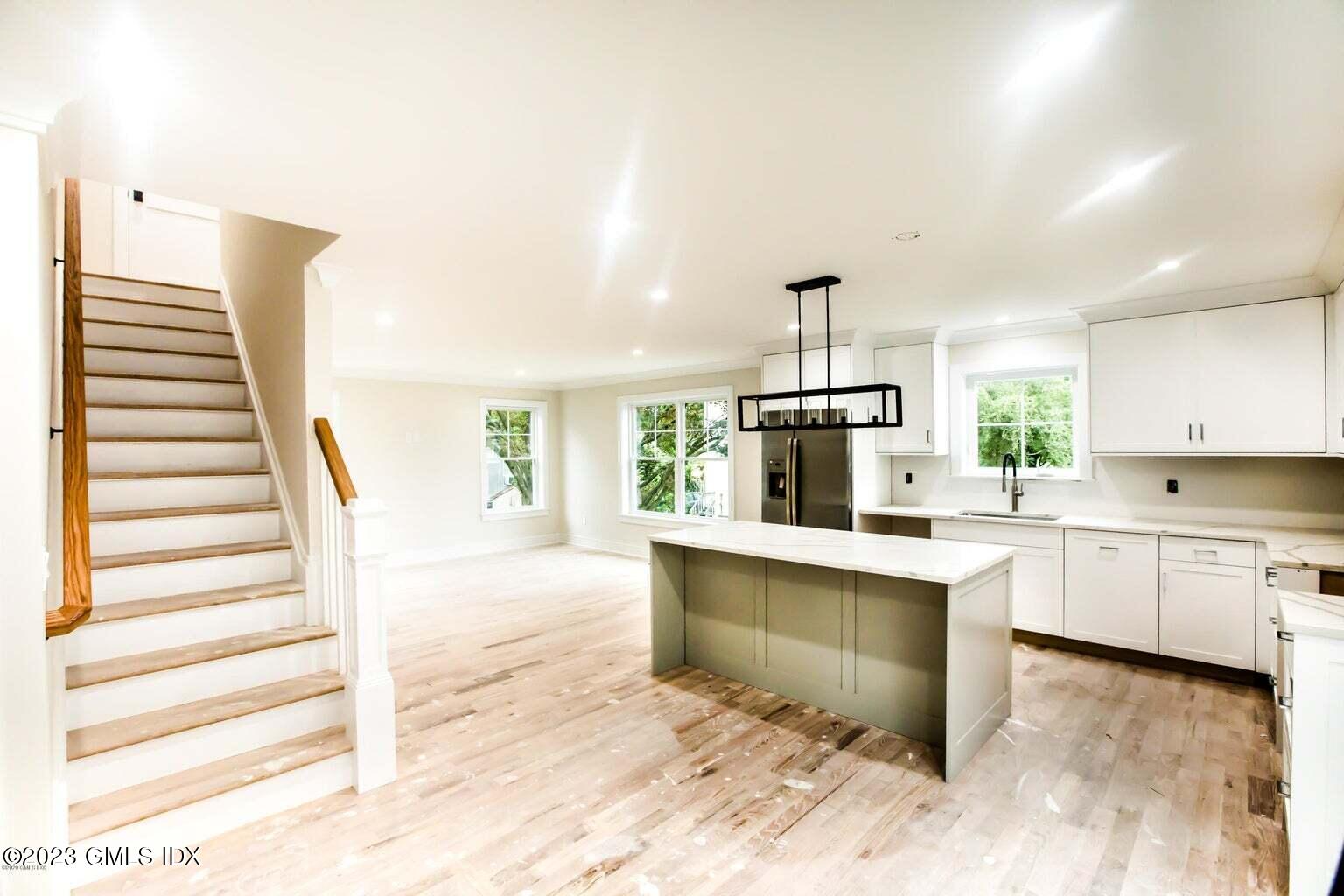 292 Delavan Avenue, Unit 2 Greenwich, CT 06830 - Photo 6 of 22 a kitchen with white cabinets and white appliances
